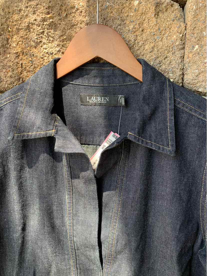 Dark denim Ralph Lauren shirt with pointed collar and visible stitching on wooden hanger.