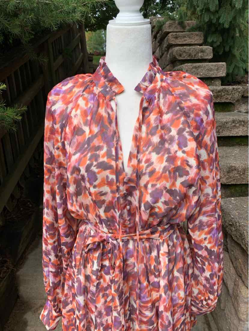 Women's long-sleeve blouse in abstract orange, purple, and white pattern with cinched waist and mandarin collar.