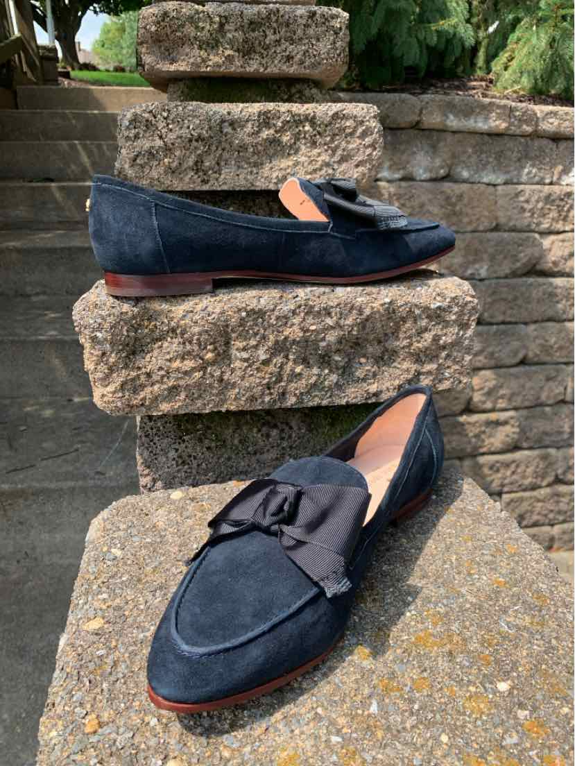 Black suede loafers with bow detail, almond toe, and low stacked heel, size 10.