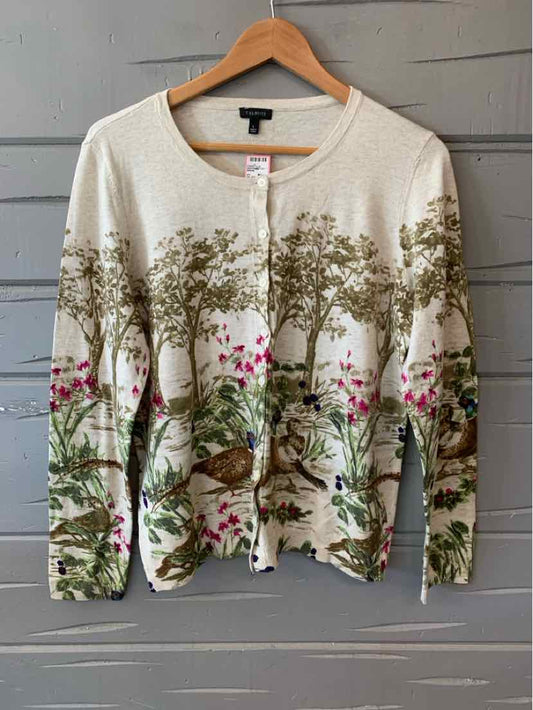 Cream cardigan with front buttons featuring green tree and pink floral scenic pattern.