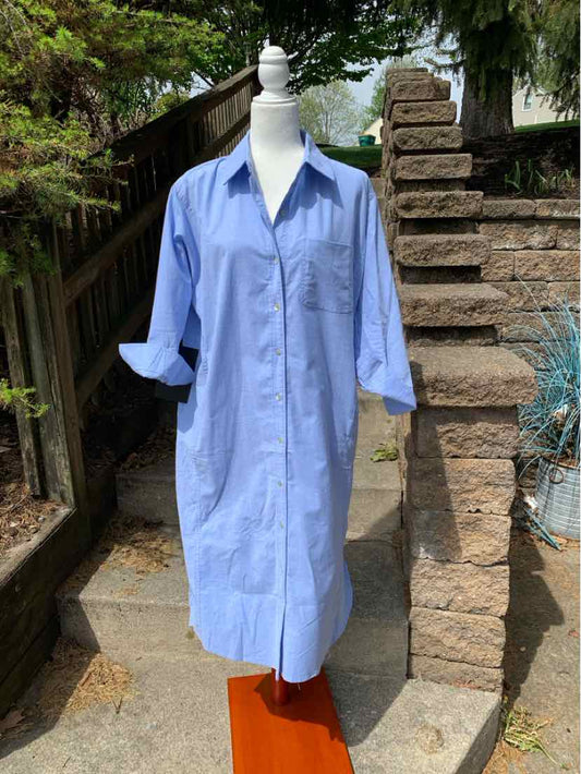 Light blue long shirt dress with collar and rolled-up sleeves on white mannequin outdoors.