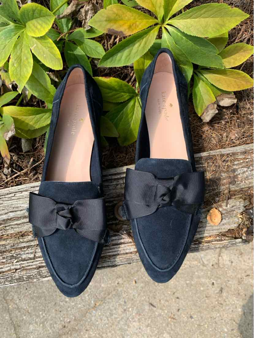 Black suede loafers with pointed toes and large fabric bows on top, size 10.