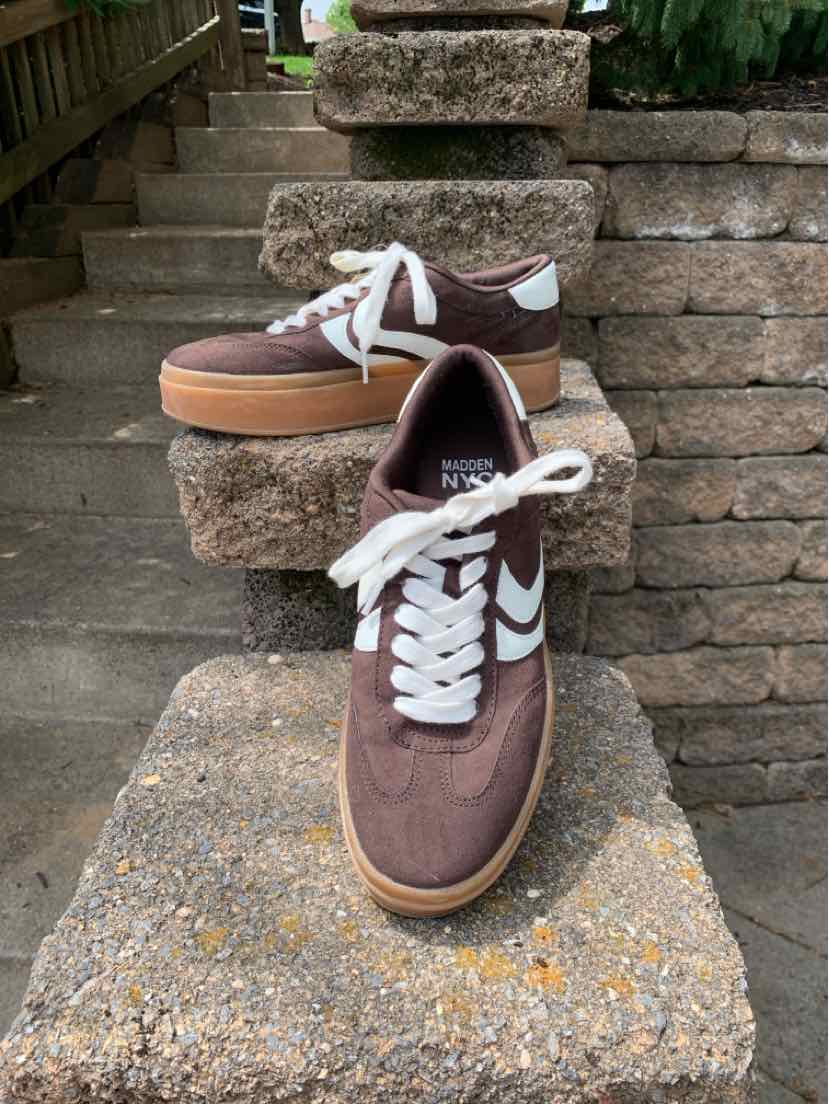 Brown low-top sneakers with white laces, white accents, and gum rubber soles in size 9.