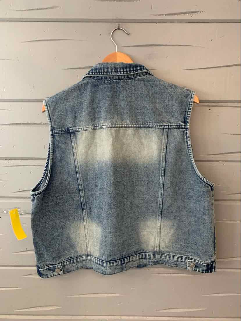 Sleeveless blue denim vest with faded wash pattern and raw, frayed armholes on a wooden hanger.