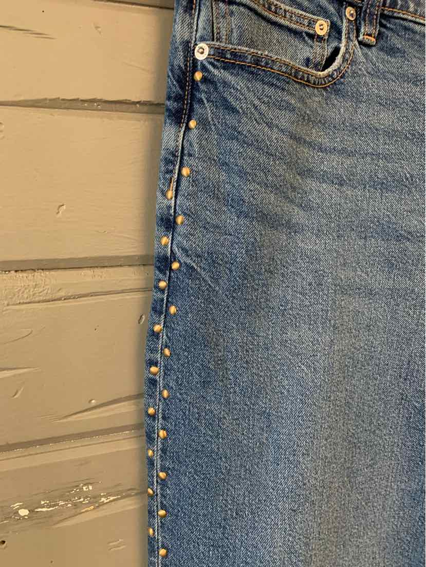 Blue denim jeans with silver studs along side seams, size 14, mid-rise waist.