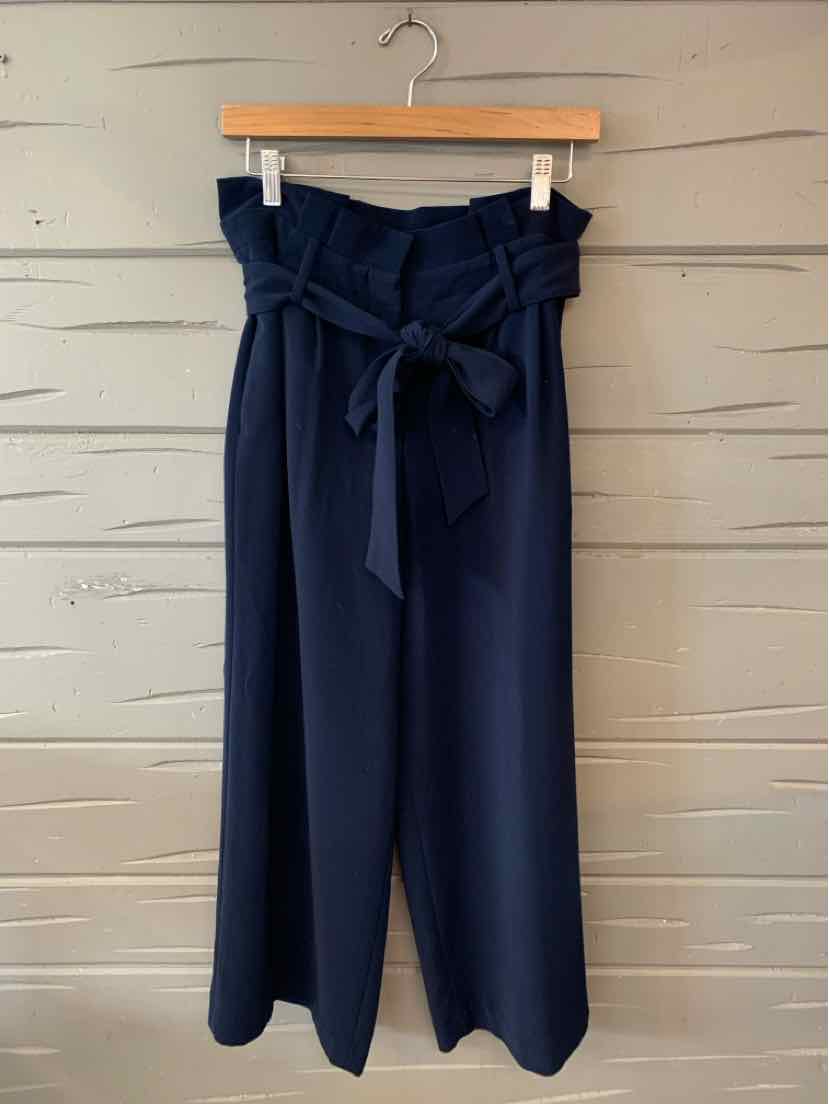 Navy blue high-waisted pants with wide legs and a fabric belt tied in a bow at the waist.