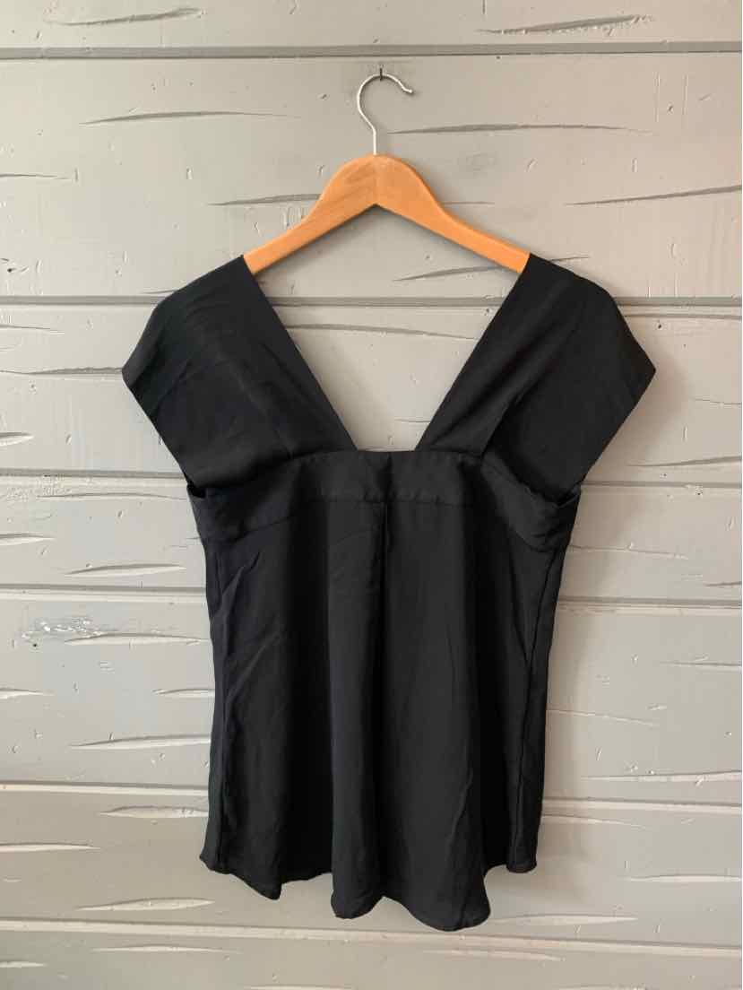 Black short-sleeve blouse with deep V-neck and fitted waist on wooden hanger.
