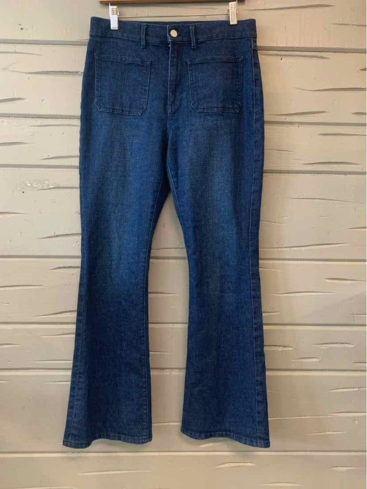 High-waist blue denim jeans with front patch pockets and slight flare leg, size 6.