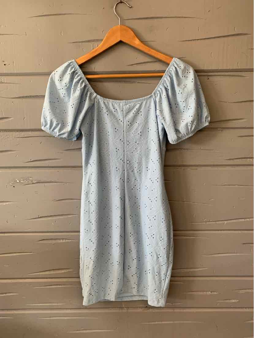 Light blue eyelet dress with puff sleeves and square neckline on wooden hanger.