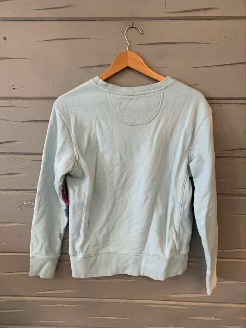 Light blue long-sleeve crewneck sweatshirt with a relaxed fit hanging on wooden hanger.