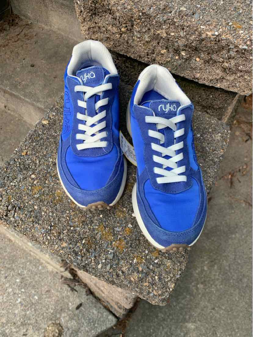 Blue athletic sneakers with white laces and thick white soles, mesh and synthetic upper.