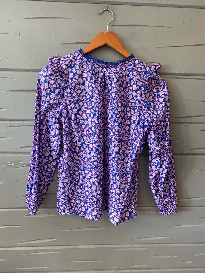 Long-sleeve blouse in blue with small pink and white floral print, crew neckline, fitted cuffs.