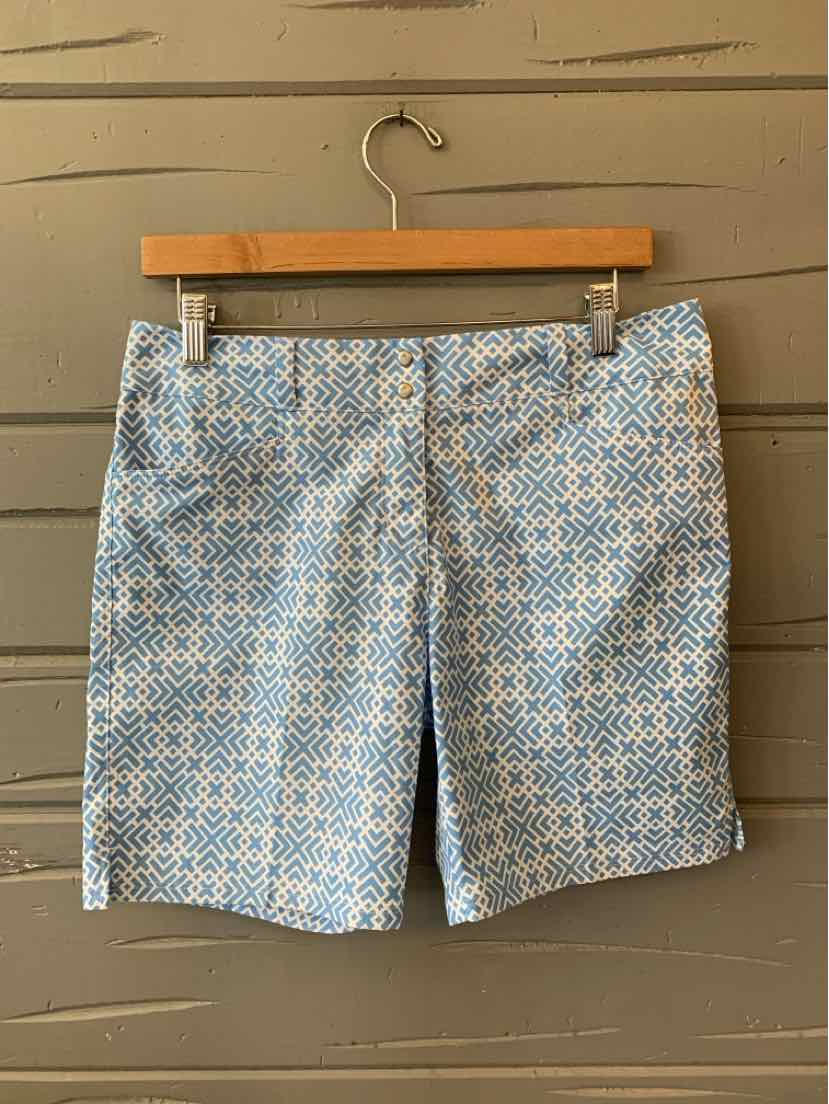 Blue and white geometric print women's shorts with belt loops, size 6, hanging on wooden hanger.