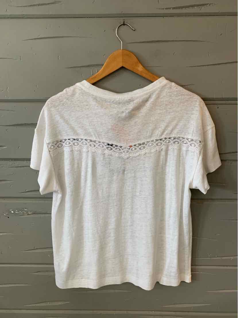 White short-sleeve blouse with lace detail across upper back on wooden hanger.
