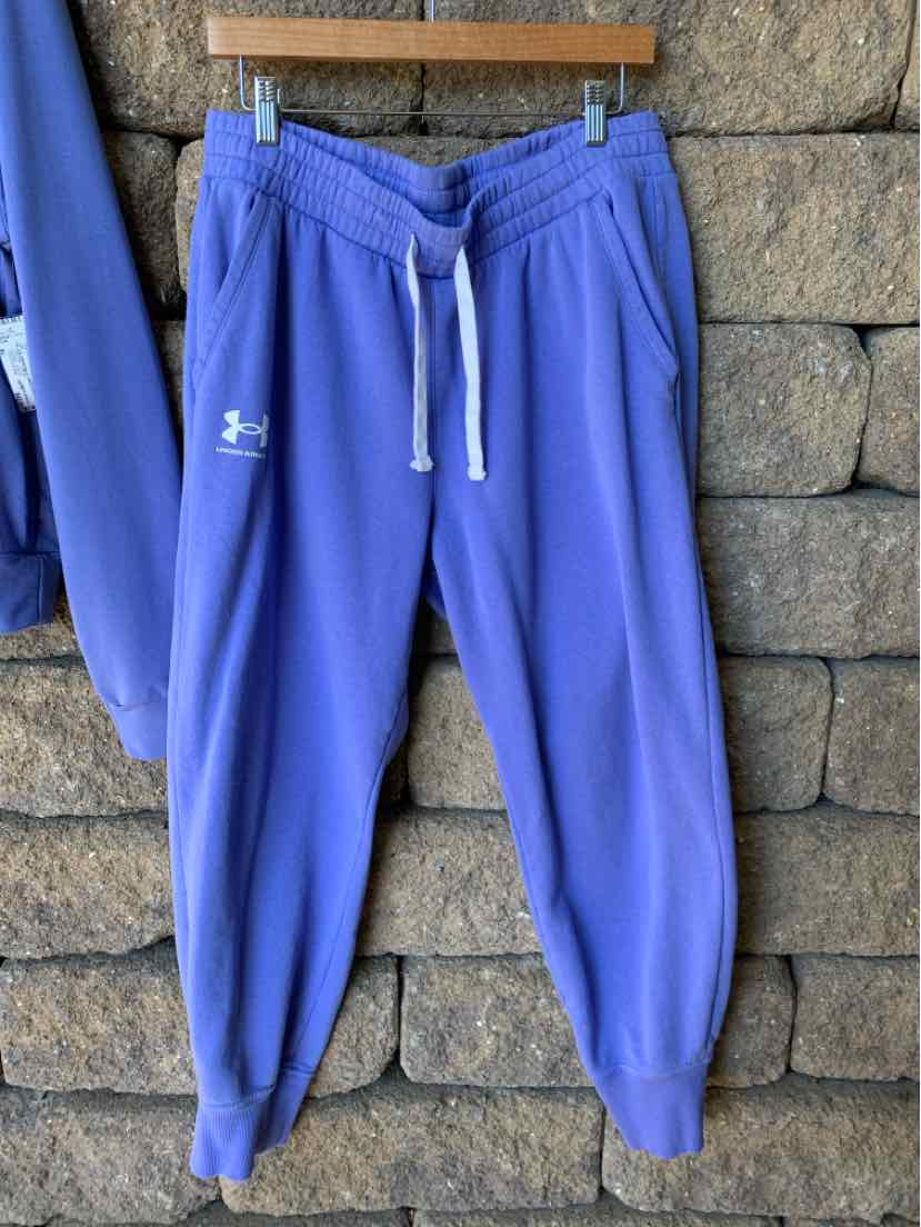 Bright blue Under Armour women’s jogger pants with an elastic waistband, drawstring, tapered legs, and logo.