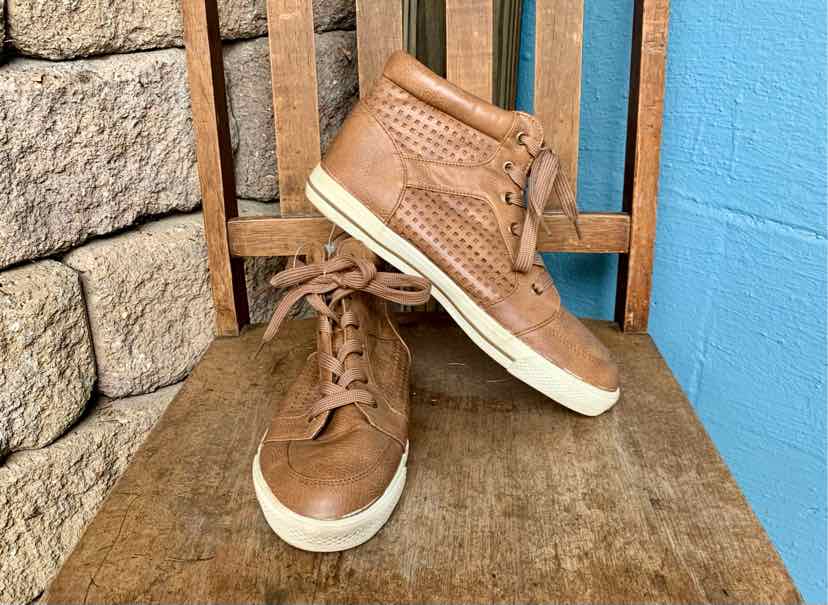 Brown leather high-top boots with perforated details and white rubber soles, size 10.