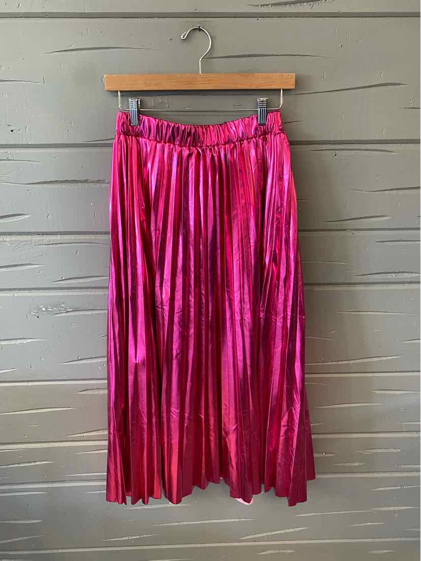 Pink metallic pleated midi skirt with elastic waistband hanging on wooden hanger.
