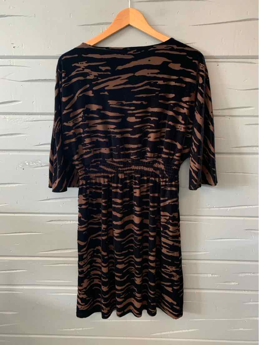 Black and brown zebra print dress with three-quarter sleeves and a cinched waist.