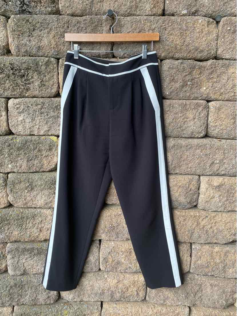 Black tapered pants with white side stripes and a white-trimmed waistband in size 4.