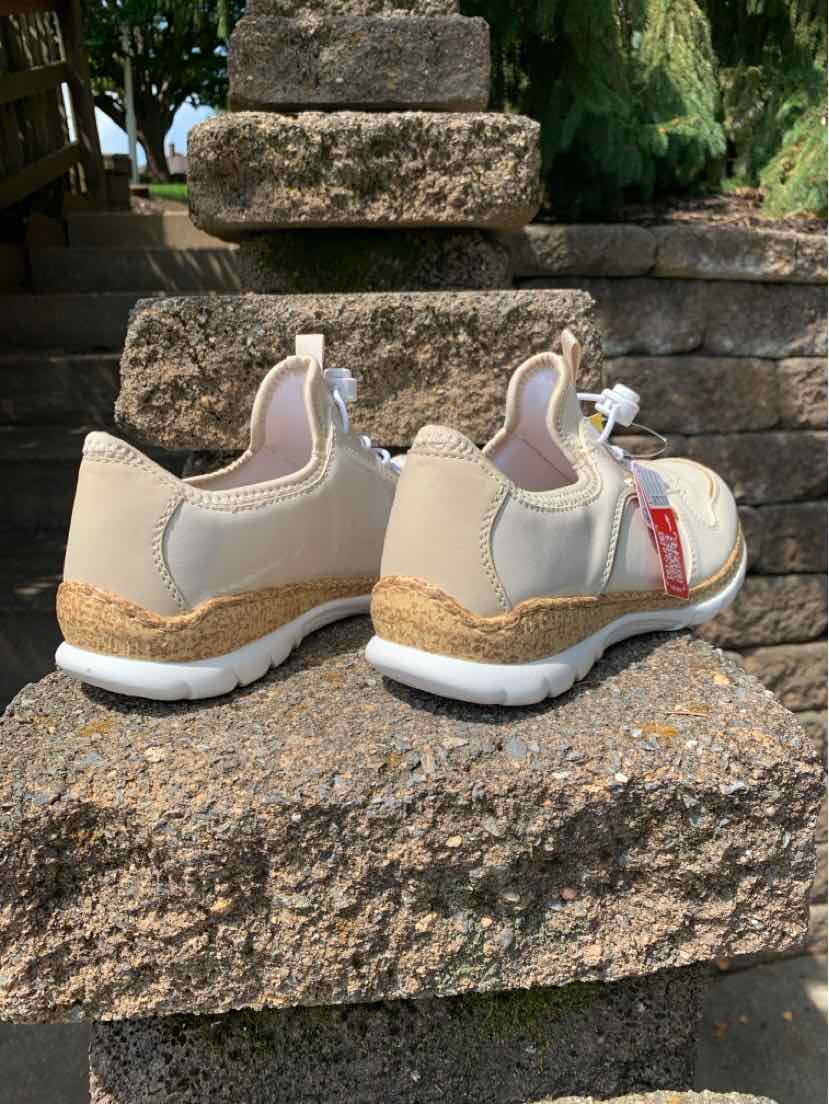 Beige low-top sneakers with white soles and jute rope detailing around the midsole, lace-up closure.