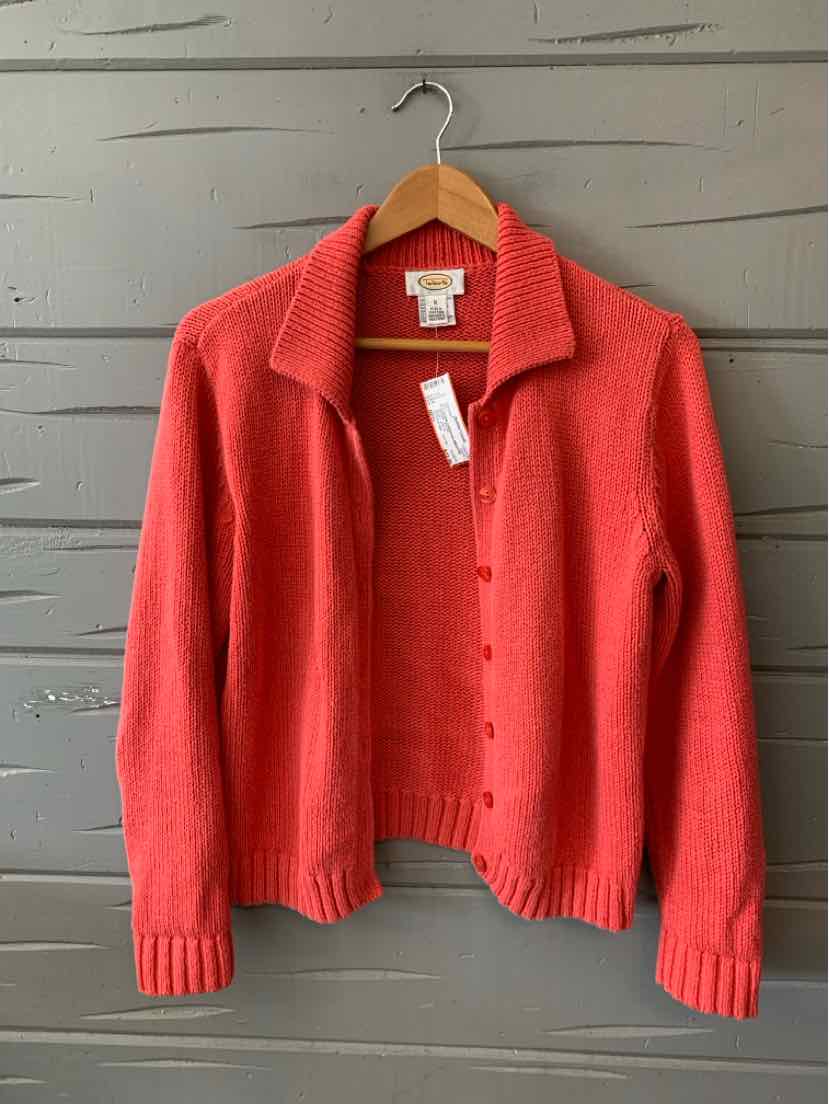 Coral-red knit cardigan with full button front, ribbed cuffs, and collar on wooden hanger.