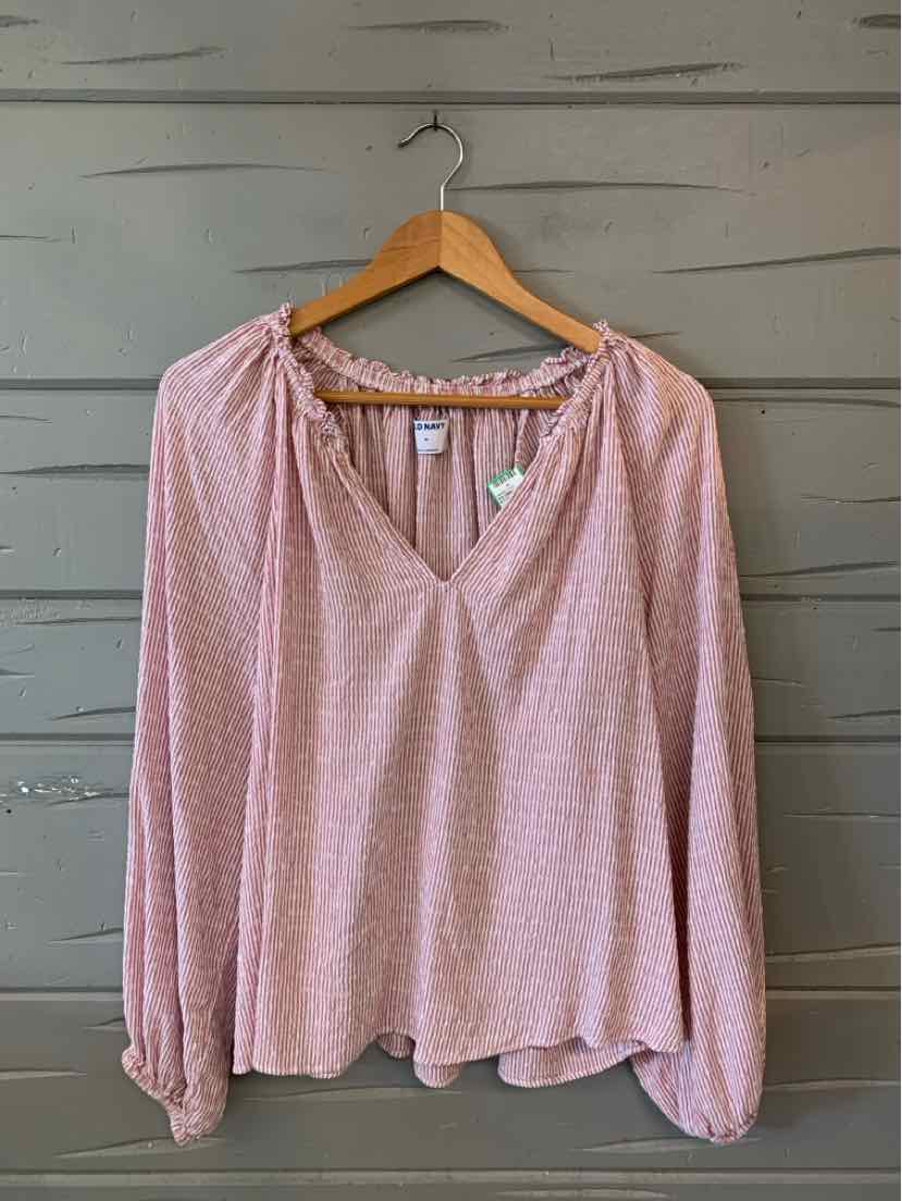 Light pink long-sleeve blouse with subtle white stripes, V-neck, and gathered elastic cuffs, displayed on wooden hanger.