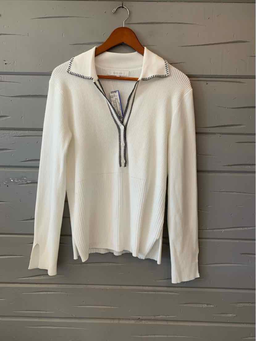 White long-sleeve pullover with quarter-zip collar and black trim on zipper.
