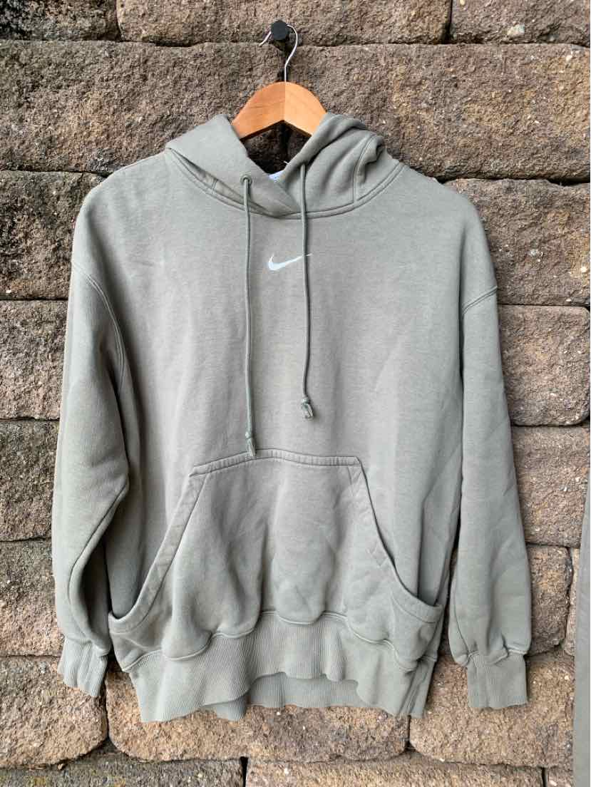 Olive green Nike hoodie with front pocket, drawstring hood, and white Nike logo on chest.