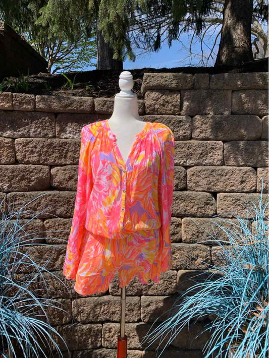Pink and orange floral lightweight long-sleeve blouse with V-neck and gathered waist on mannequin.