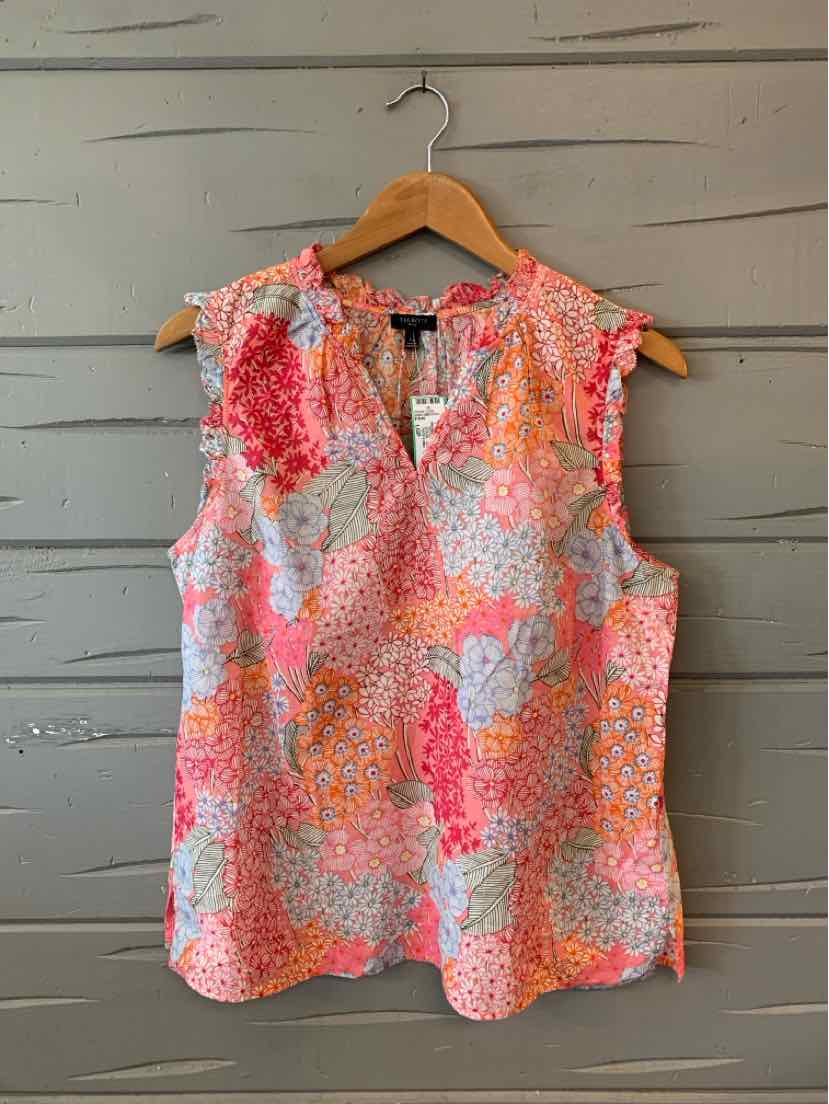 Sleeveless blouse with pink and orange floral print and ruffled shoulder detail.