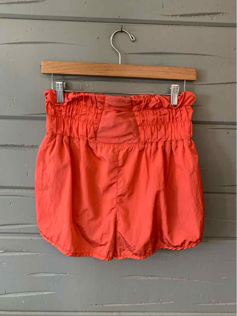 Coral pink shorts with elastic paperbag waist and gathered detail, relaxed fit, lightweight fabric.