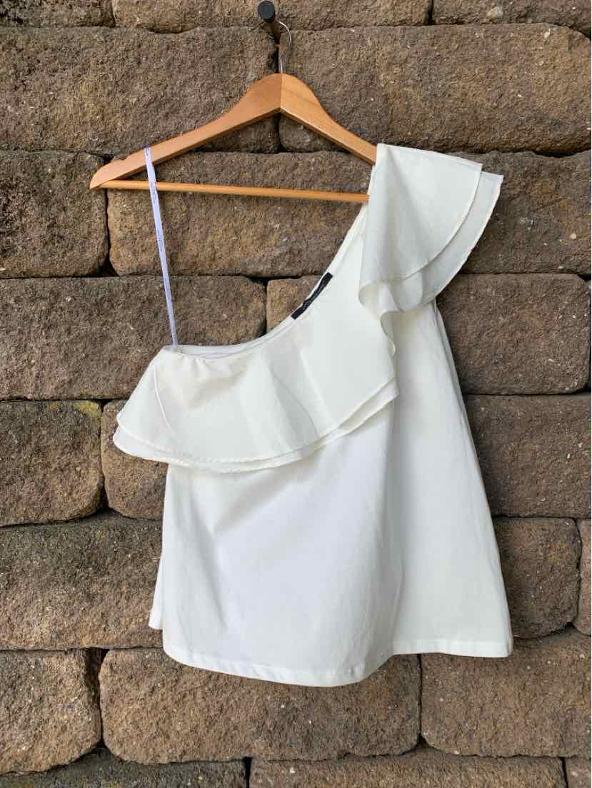 White one-shoulder top with ruffled overlay and thin adjustable strap on hanger.