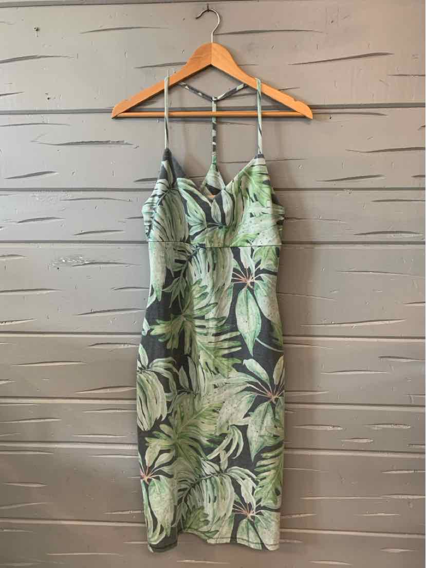 Green tropical print midi slip dress with adjustable thin straps and V-neckline.