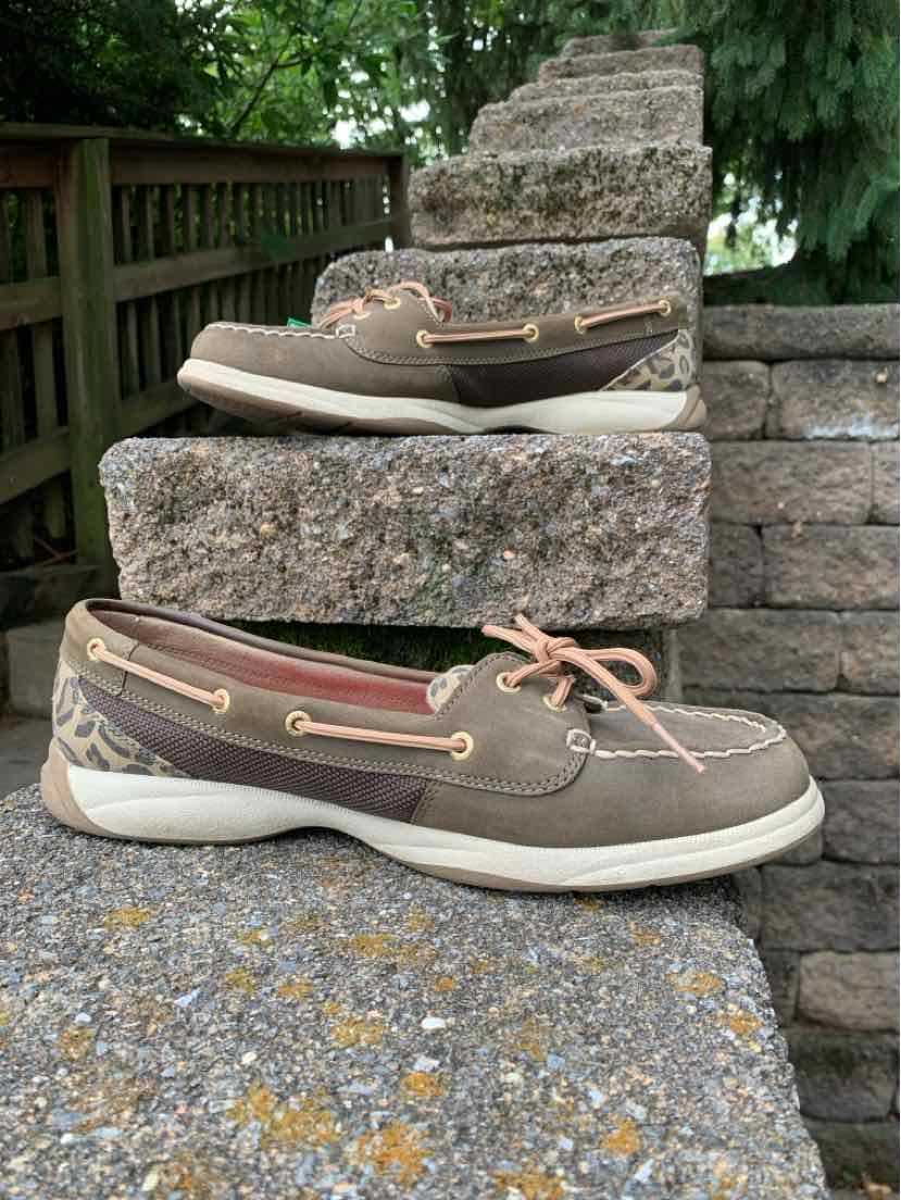 Brown and leopard print boat shoes with white soles and pink laces, size 11.