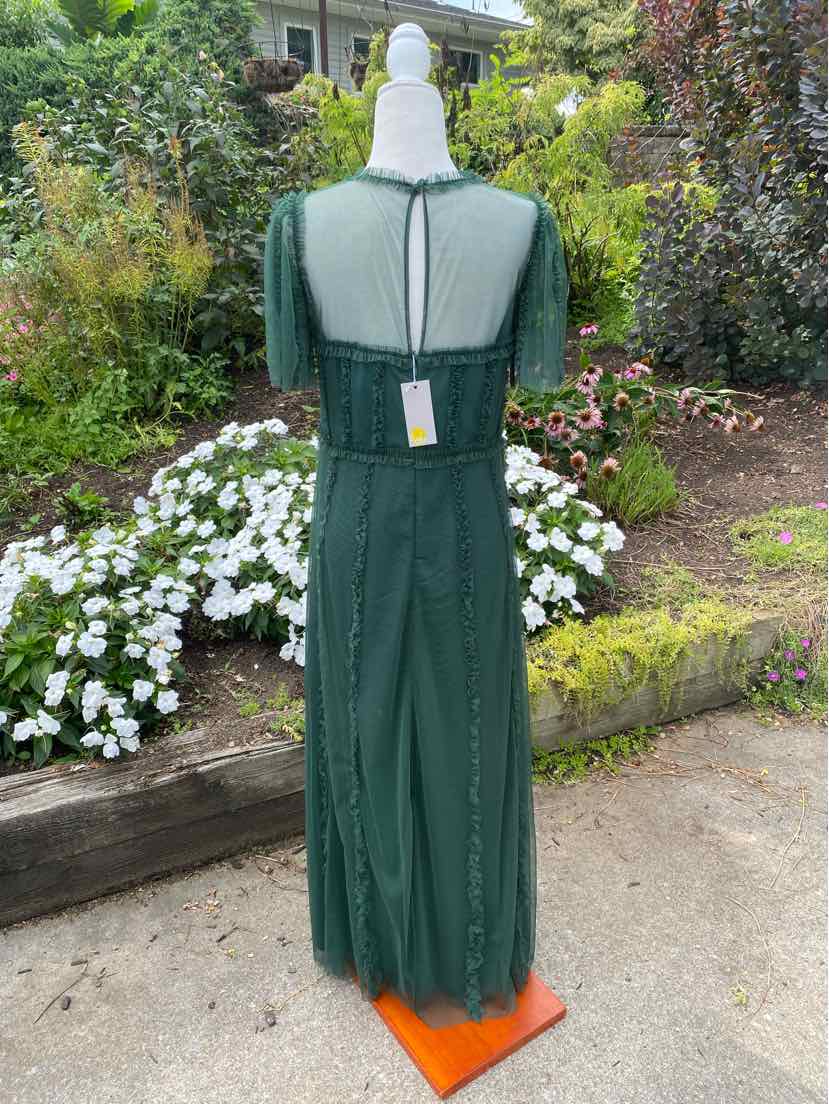Dark green maxi dress with sheer short sleeves and back zipper closure on mannequin outdoors.
