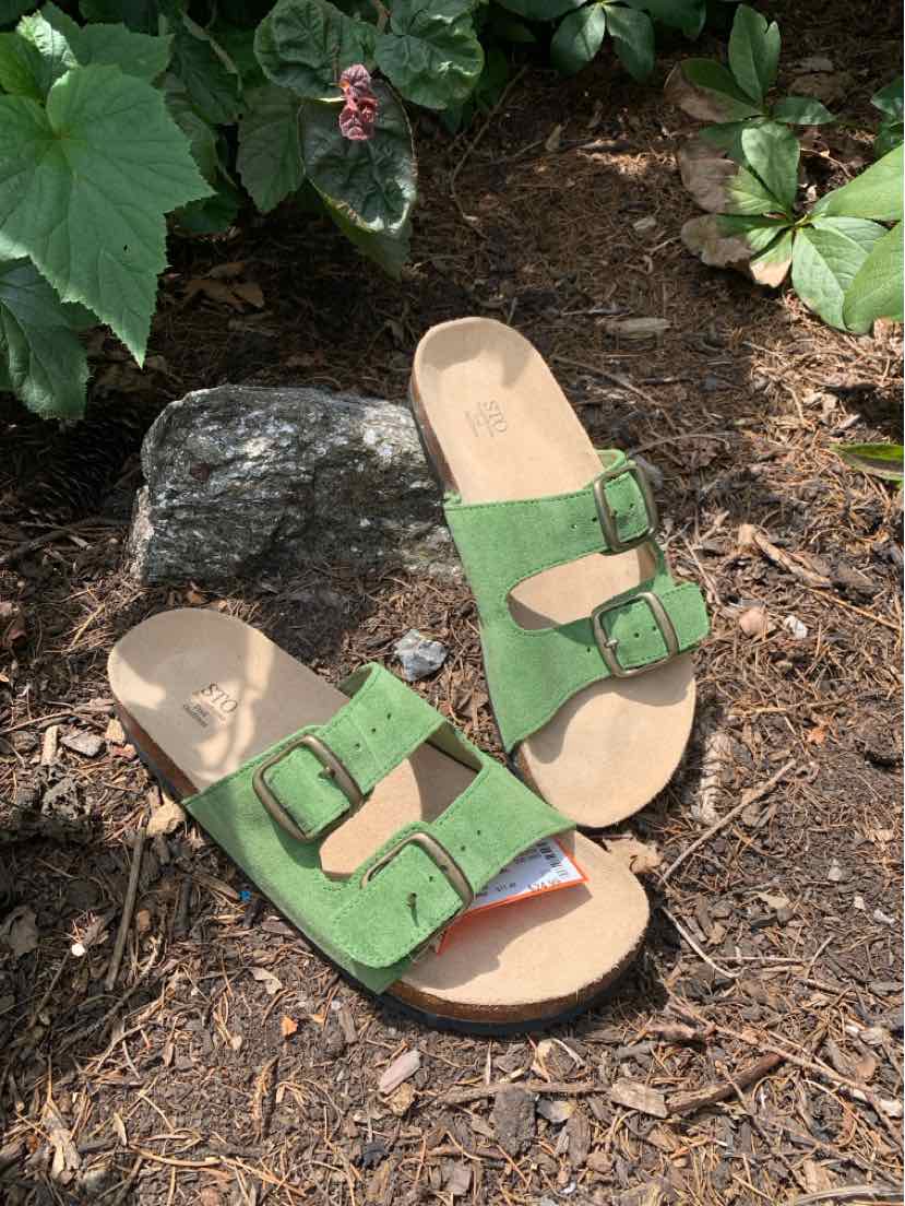 Green suede sandals with two adjustable buckle straps and tan footbeds, size 10.