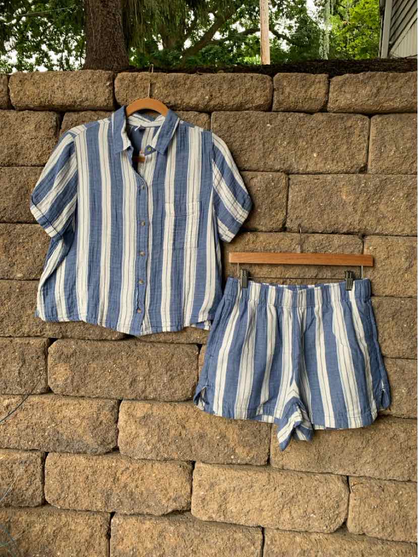 Blue and white vertical striped short-sleeve button-up shirt with matching shorts.