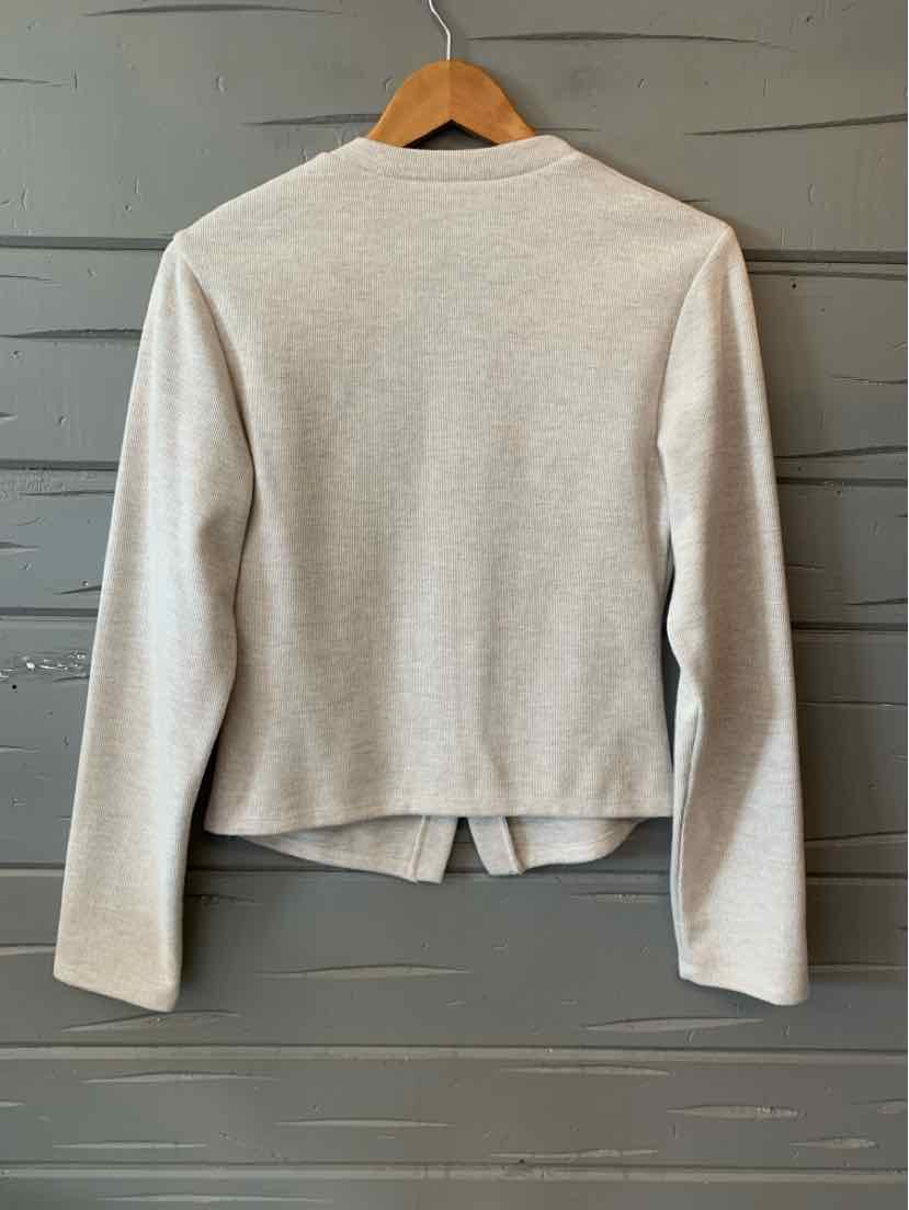 Beige long-sleeve knit sweater with a slightly cropped hem and soft texture.