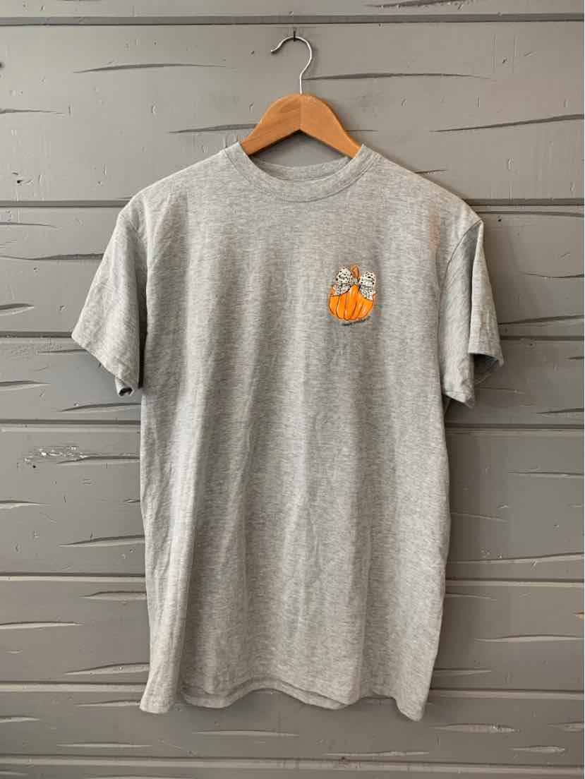 Gray short-sleeve crewneck t-shirt with a small orange and white graphic on the left chest, hanging on a wooden hanger.