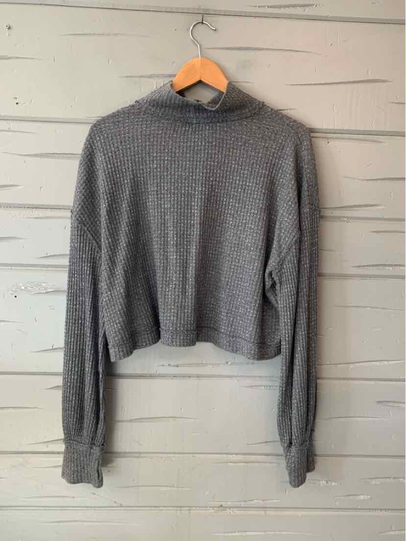 Gray waffle-knit Free People long-sleeve top with a cropped, relaxed fit and high neckline.