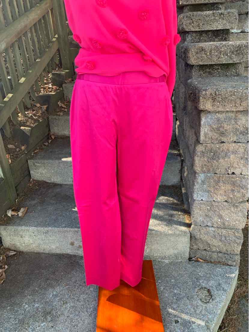 Bright pink two-piece lounge set with relaxed fit pants and matching top.