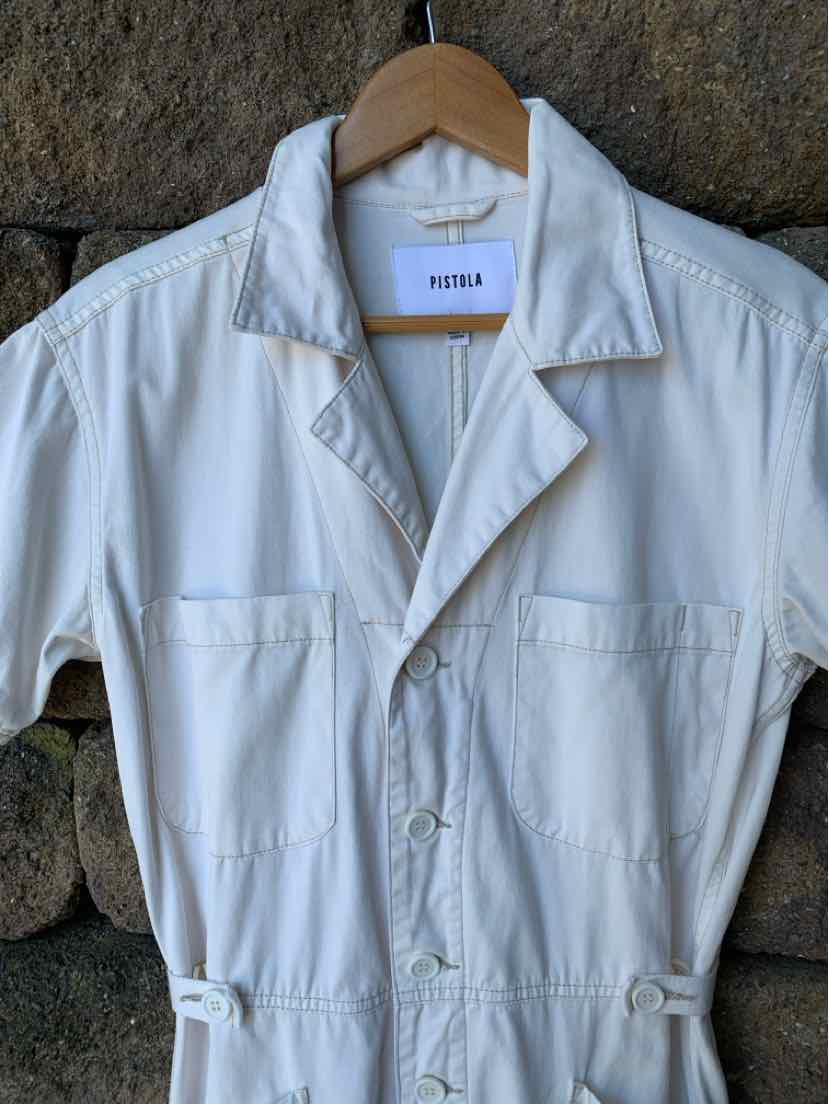 Off-white short-sleeve button-up coverall with chest pockets and adjustable side tabs.