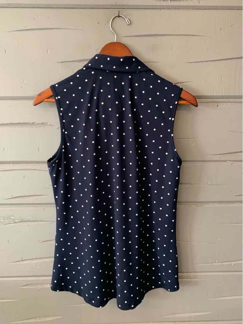 Navy blue sleeveless blouse with white polka dots and a collared neckline.