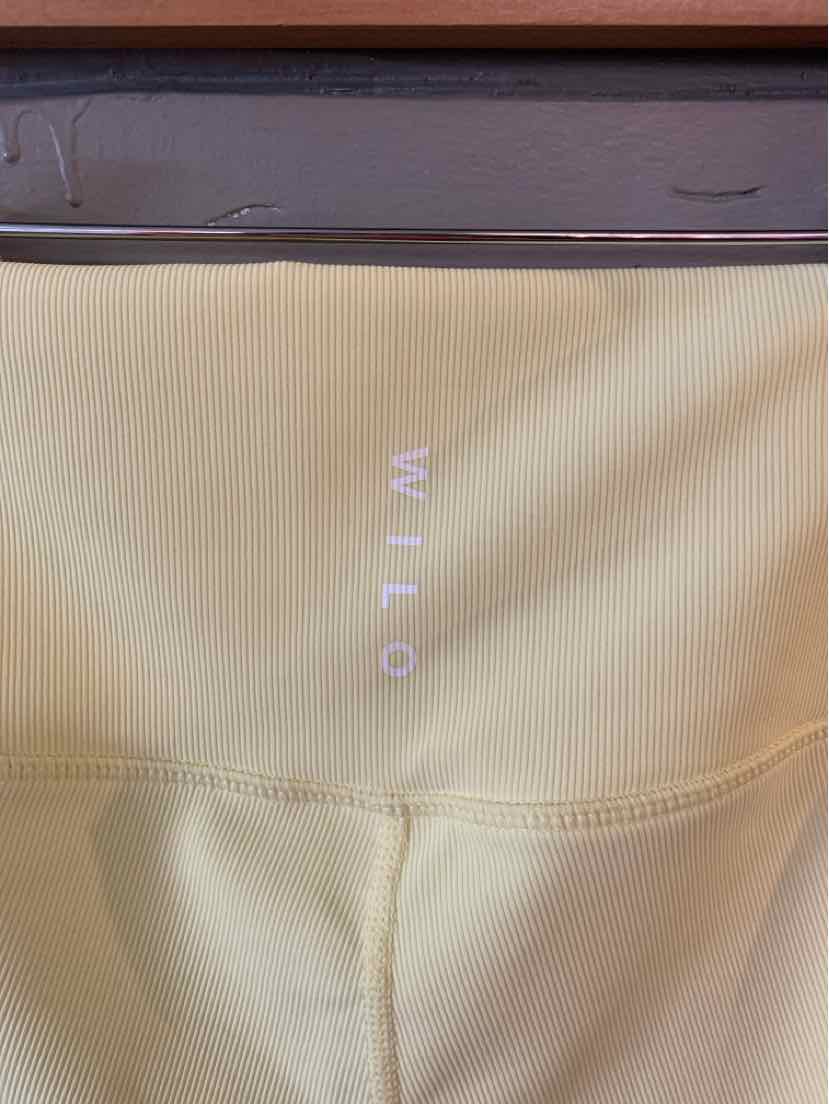 Light yellow seamless fabric with centered white WILO logo and contoured stitching detail.