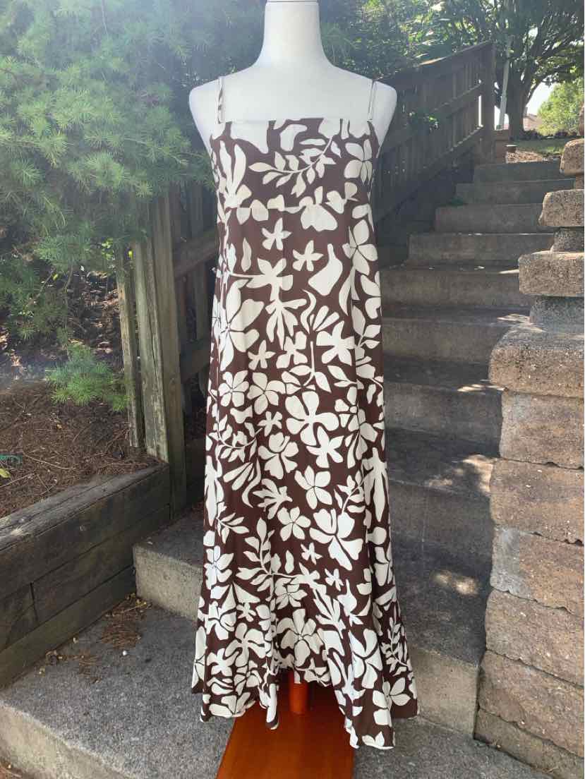 Brown and white floral print spaghetti strap maxi dress with ruffled hem.