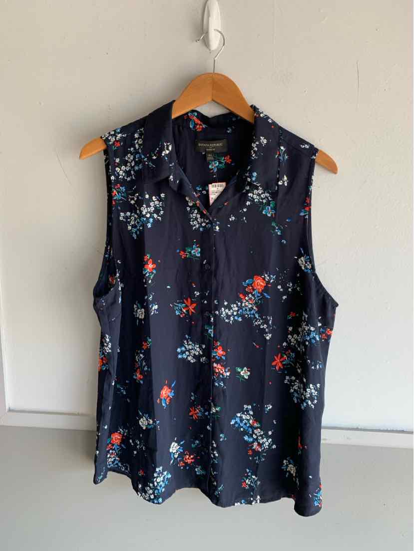 Navy sleeveless blouse with red and white floral pattern and V-neck, size XL.