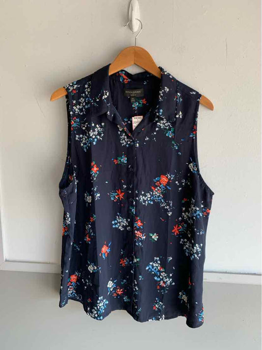 Navy sleeveless blouse with red and white floral pattern and V-neck, size XL.