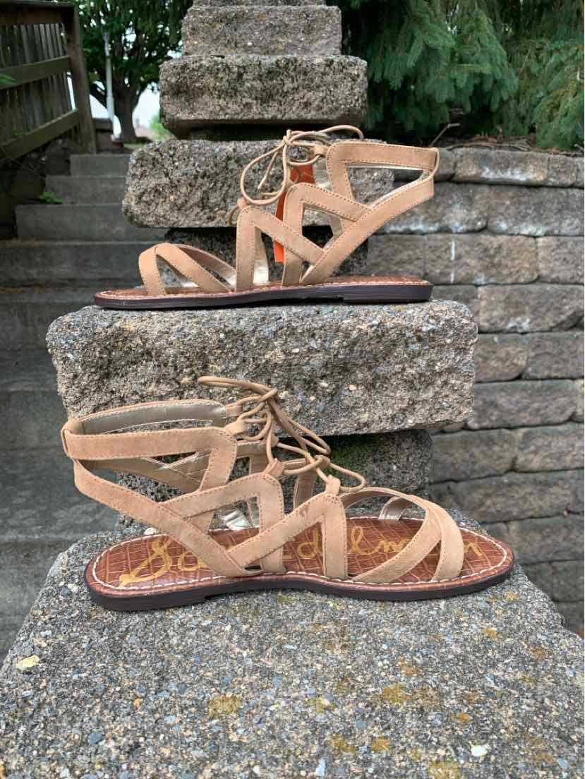 Tan suede flat sandal with crisscross straps and lace-up detail, size 8.