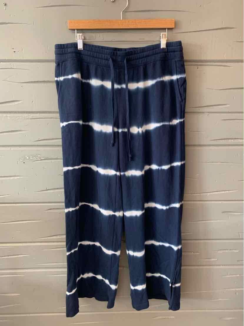 Navy blue wide-leg pants with white horizontal tie-dye stripes and elastic waistband.