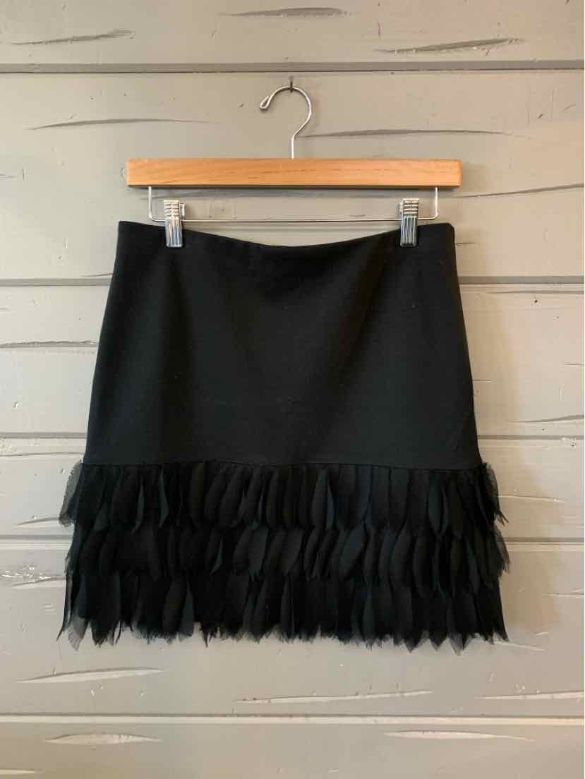 Black A-line skirt with layered feather trim hem, size 4P, lightweight fabric.
